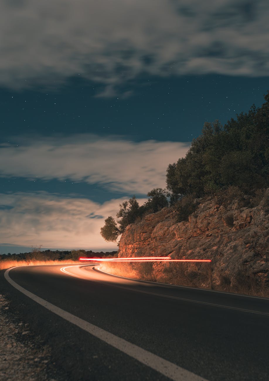 scenic curved road at night with light trails
